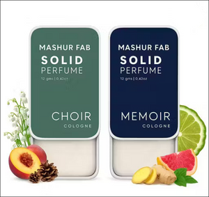 Mashur Fab 12g solid perfume: Green 'Choir' and blue 'Memoir' metal tins with fruit, flower, and spice scent graphics.