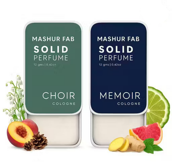 Mashur Fab 12g solid perfume: Green 'Choir' and blue 'Memoir' metal tins with fruit, flower, and spice scent graphics.