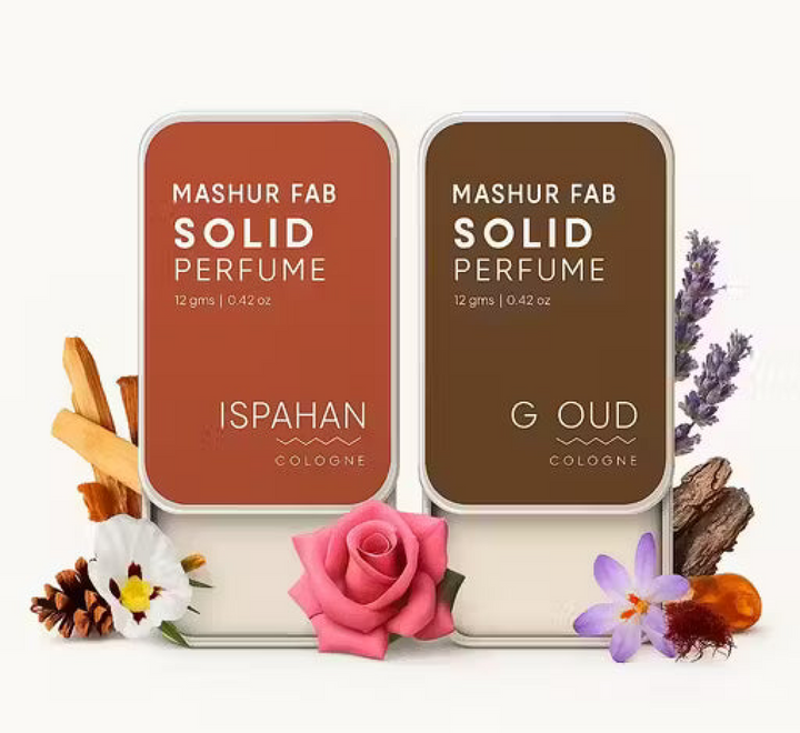 Mashur Fab Solid Perfume: orange Ispahan and brown G Oud sliding metal tins with floral and wood ingredients.