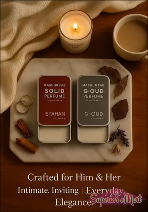 Mashur Fab maroon and grey solid perfume tins on a marble tray with a candle, coffee, and "Everyday Elegance" text.