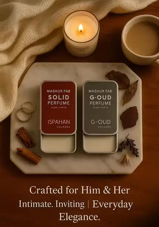 Mashur Fab maroon and grey solid perfume tins on a marble tray with a candle, coffee, and "Everyday Elegance" text.
