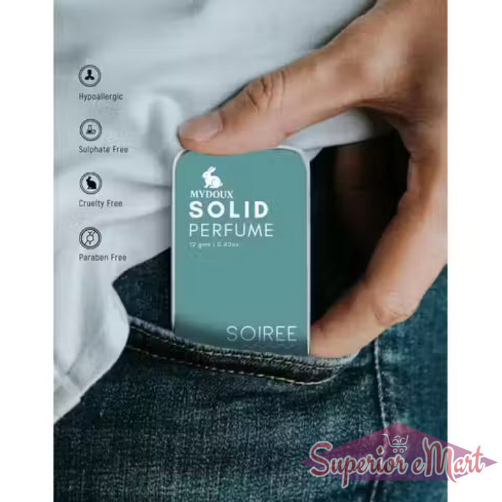 Teal Mydoux Soiree Solid Perfume tin sliding into a denim pocket. Portable, hypoallergenic, and cruelty-free.