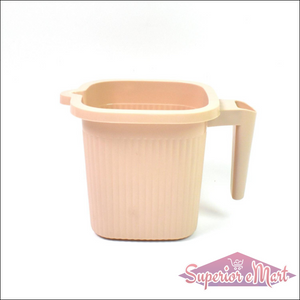 BPA free bath mug in soft pink color with a sturdy handle for easy use in the bathroom