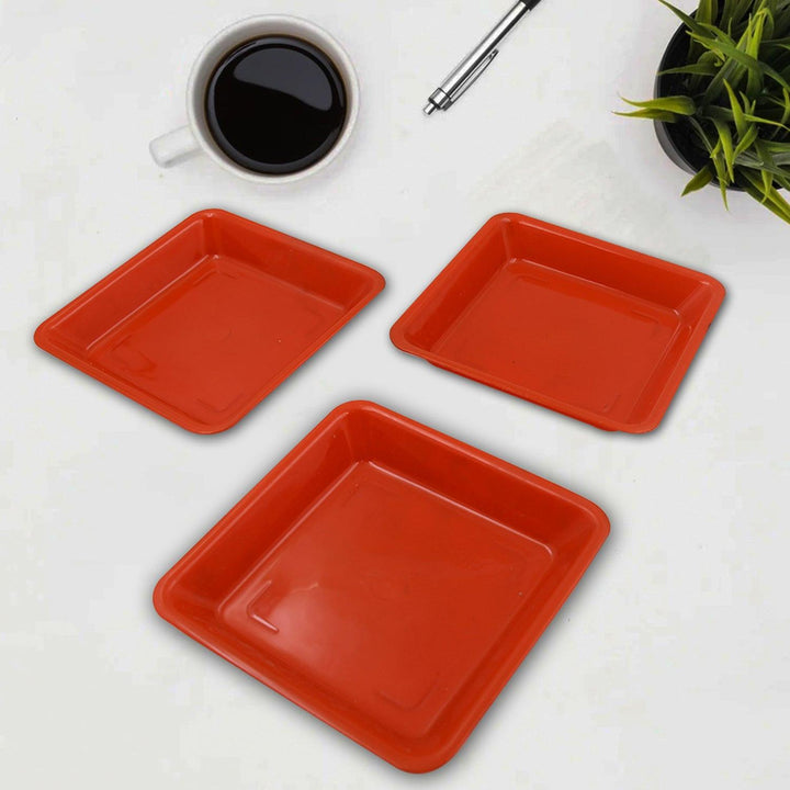 Set of three red square dinner plates in durable plastic for home dining use