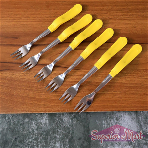 Stainless steel big fork set with yellow handled forks on wooden surface for dining and serving