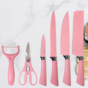 Stainless steel ceramic knife set in pink, including peeler, scissors, and various knives for kitchen use