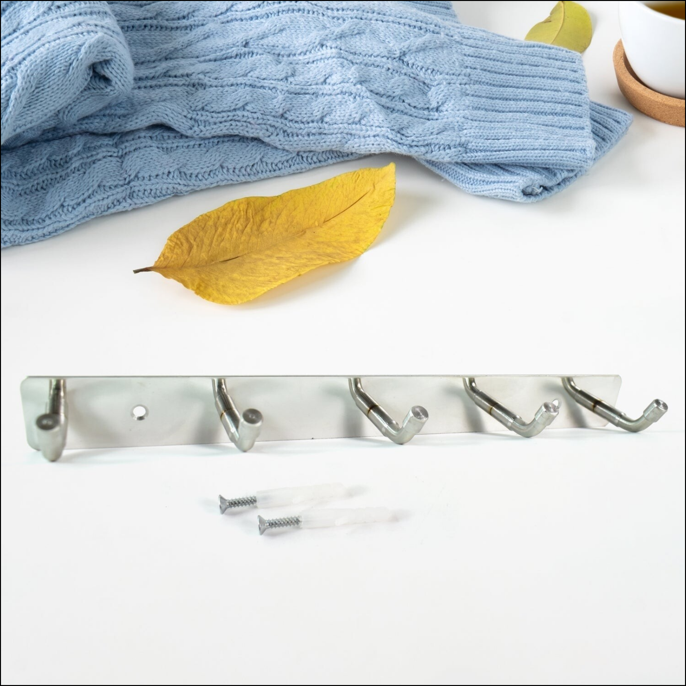 Stainless steel wall mounted coat rack with five hooks, ideal for organizing coats and accessories