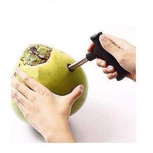 Stainless steel coconut opener tool being used on a green coconut for easy fruit access