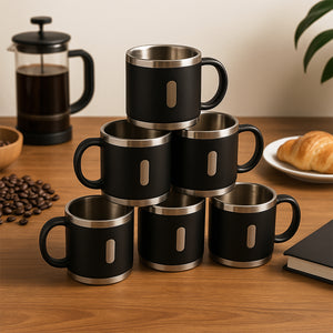 Stainless steel double wall coffee mug set stacked on a wooden table with coffee and pastries