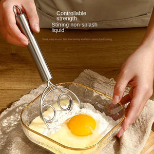 Superior eMart stainless steel dough whisk mixing egg and flour in a glass bowl for baking
