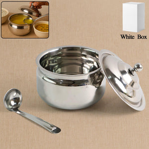 Stainless steel ghee pot with a lid and serving spoon, perfect for storing and serving ghee