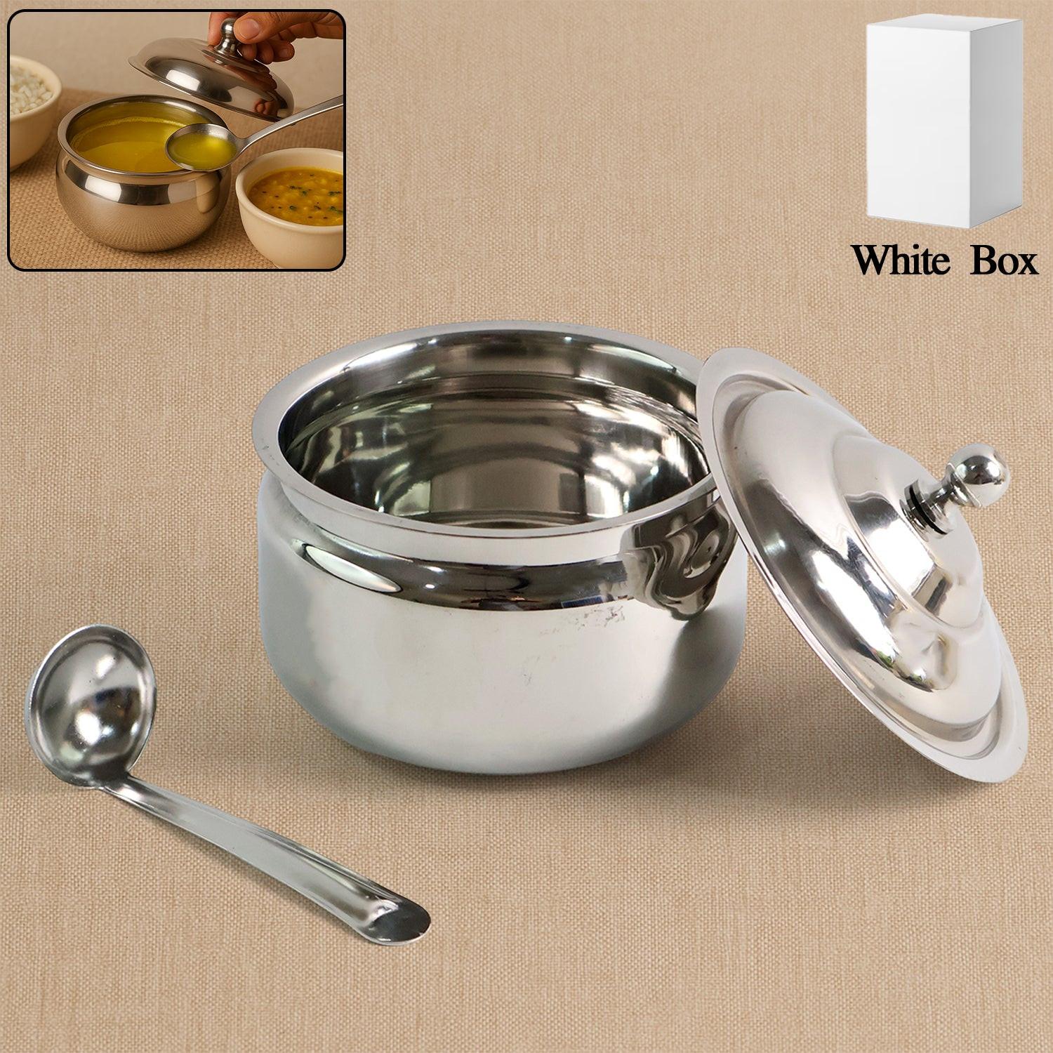 Stainless steel ghee pot with a lid and serving spoon, perfect for storing and serving ghee