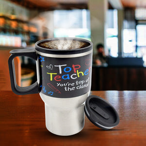 Stainless steel insulated coffee mug with fun teacher design and steam rising from hot coffee