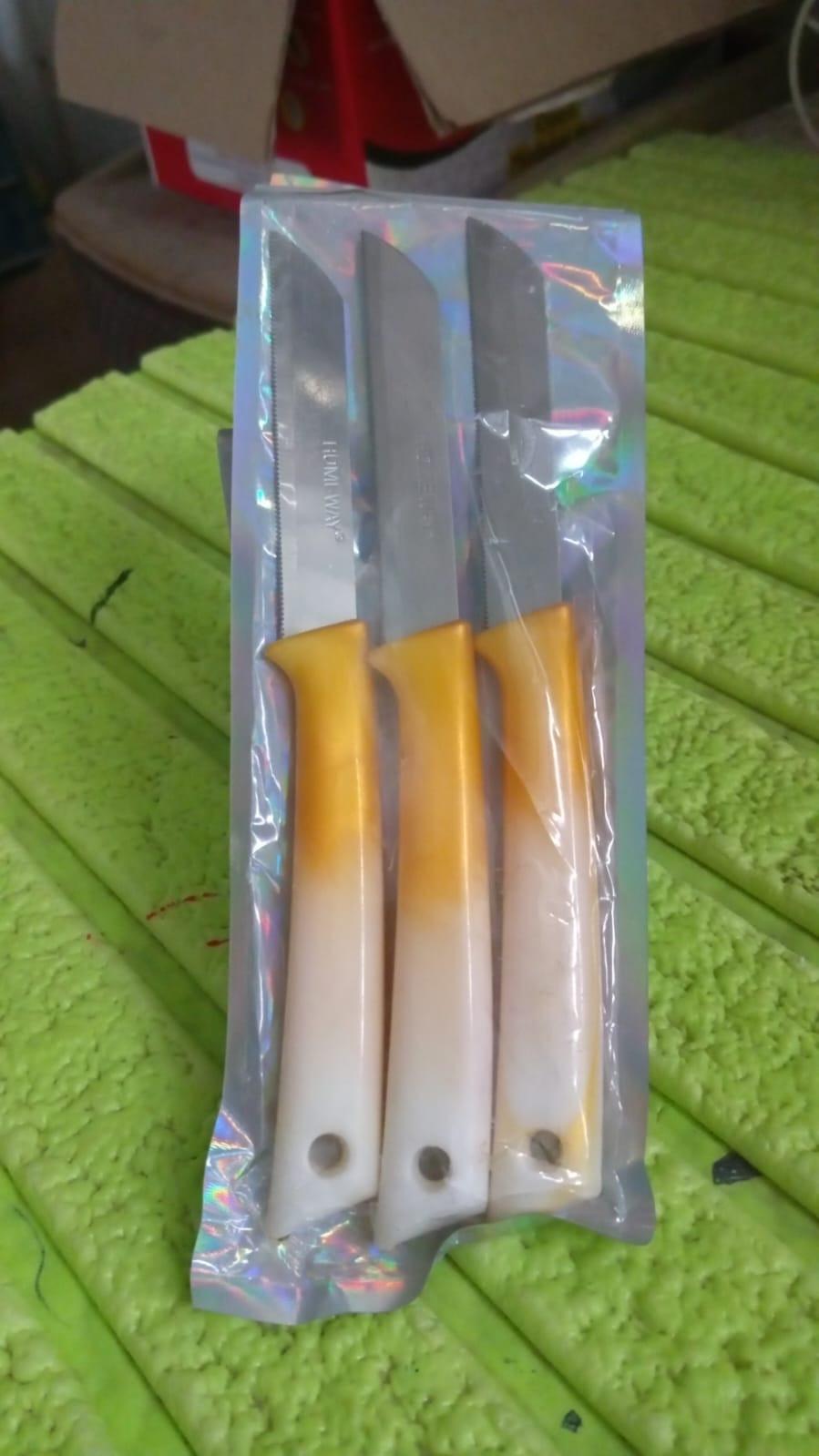 Set of three stainless steel kitchen knives with durable handles in orange and white colors