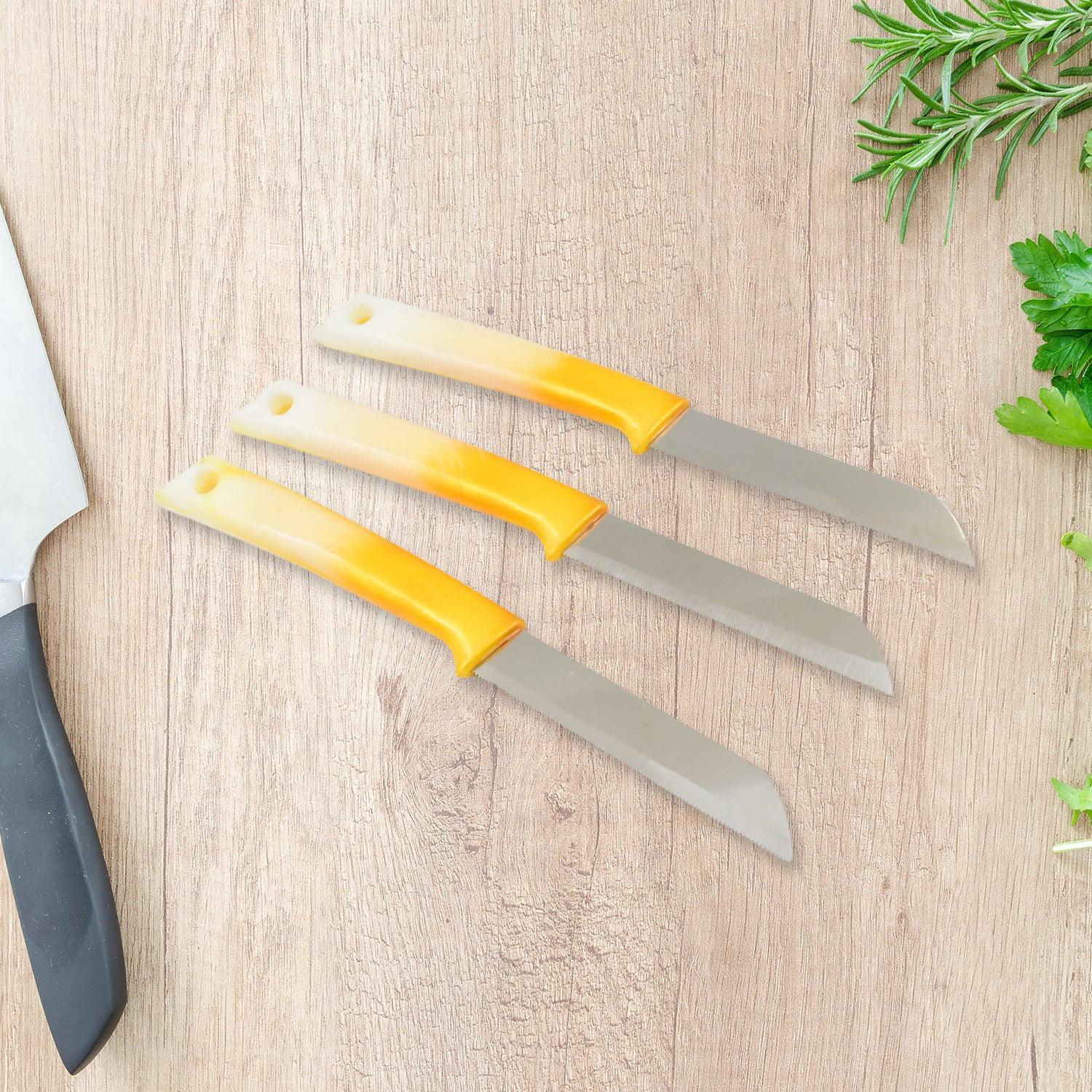 Set of three stainless steel kitchen knives with ergonomic yellow handles for easy cutting and slicing