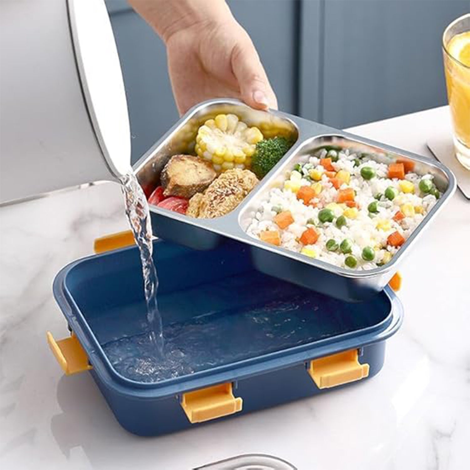 Superior eMart stainless steel lunch box with two compartments being washed in a blue container