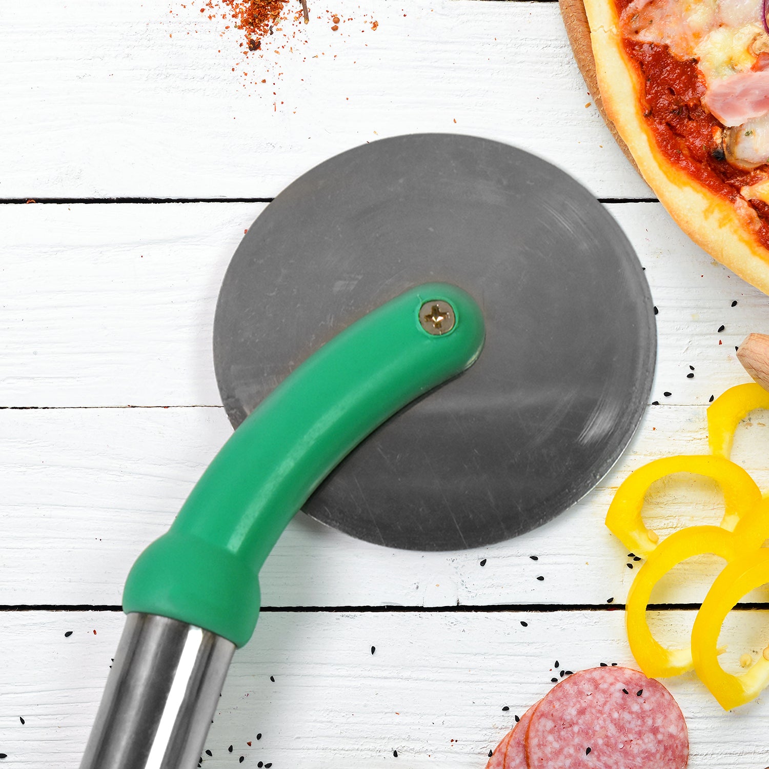 Stainless steel pizza cutter with green handle for effortless slicing through pizza and dough