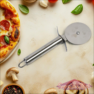 Stainless steel pizza cutter on a wooden table with fresh pizza and ingredients around it