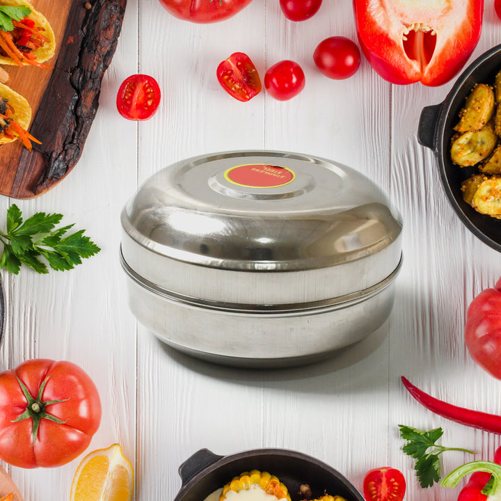 Superior eMart stainless steel tiffin box placed on white wooden table surrounded by fresh vegetables