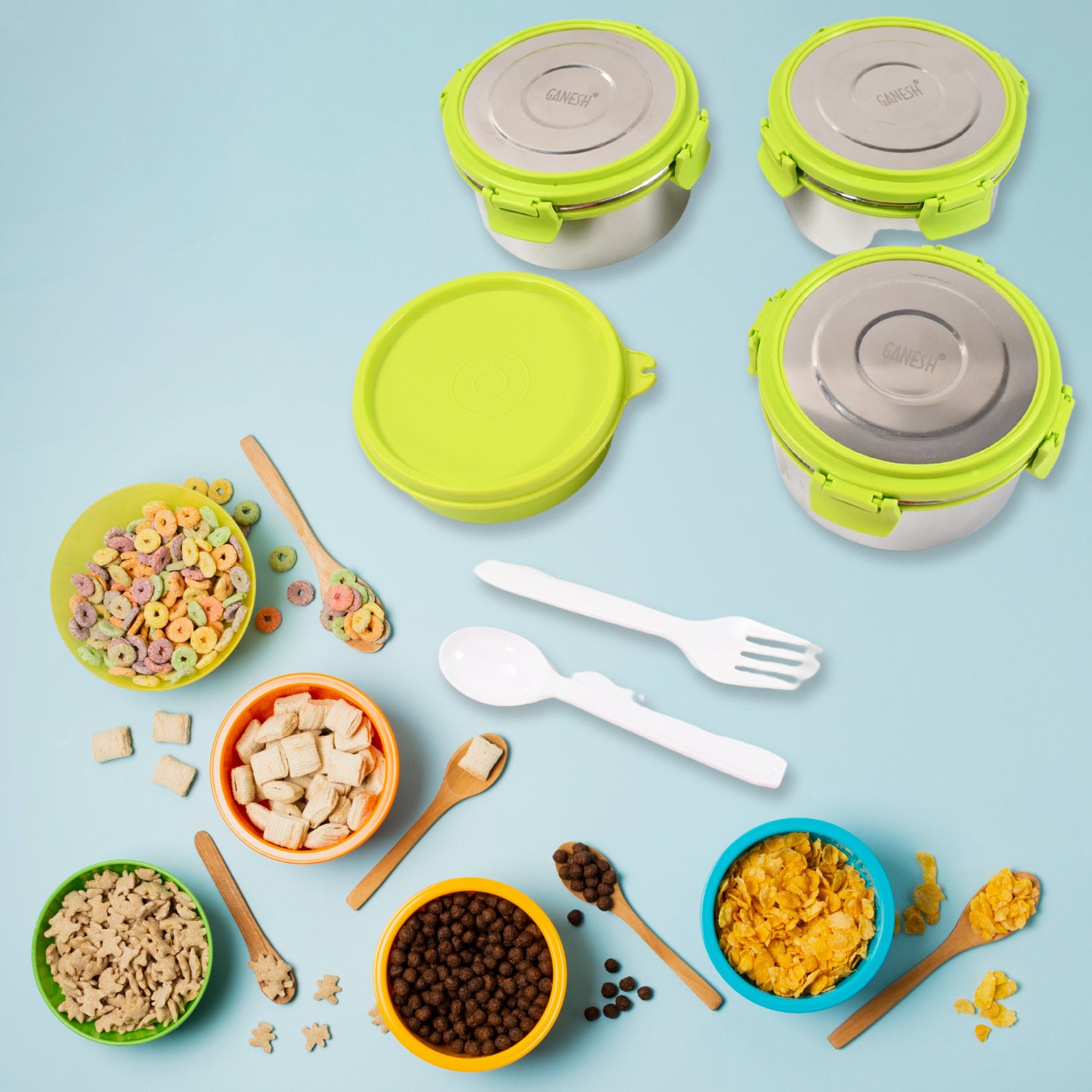 Colorful food items surrounded by a stainless steel tiffin lunch box set with airtight lids