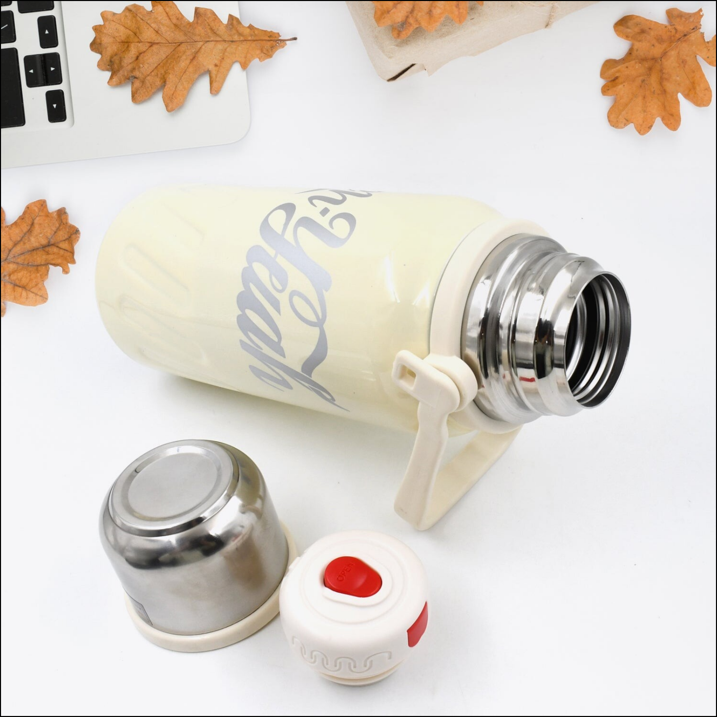 Superior eMart stainless steel vacuum insulated water bottle in cream with a removable cap and lid