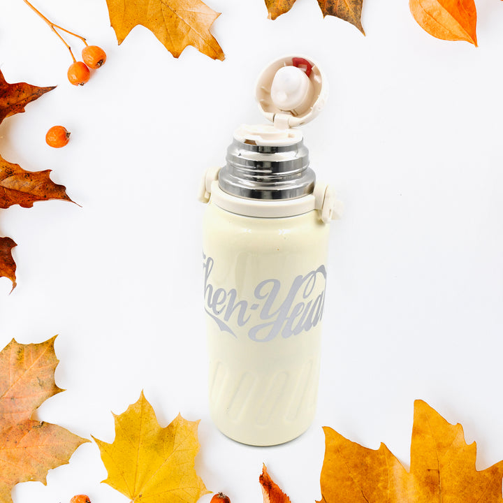 Superior eMart stainless steel vacuum insulated water bottle in cream color with a secure lid