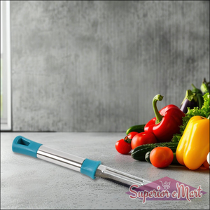 Stainless steel vegetable peeler with an ergonomic handle next to fresh vegetables on a kitchen countertop