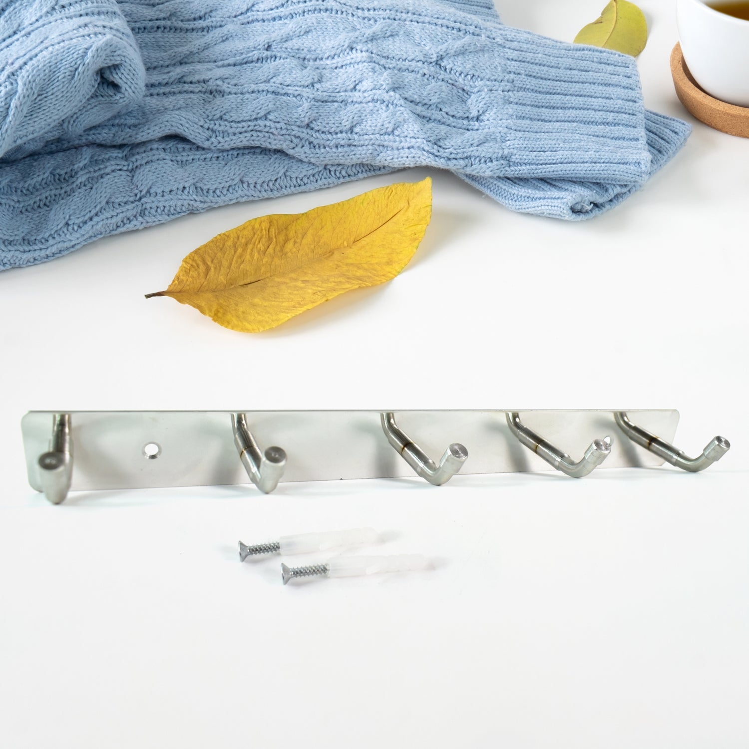 Stainless steel wall mounted coat rack with five hooks, ideal for organizing coats and accessories
