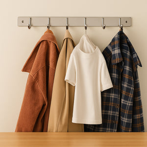 Stainless steel wall mounted coat rack displaying various coats and shirts for organized storage