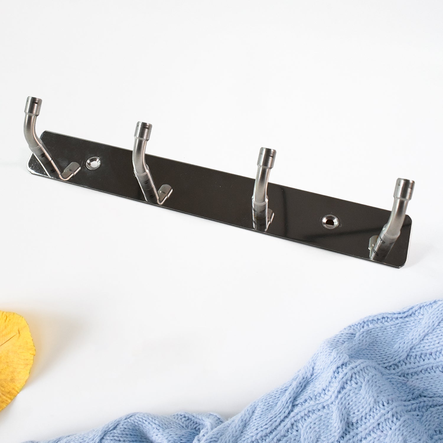 Stainless steel wall mounted coat rack with four hooks for stylish and organized entryways