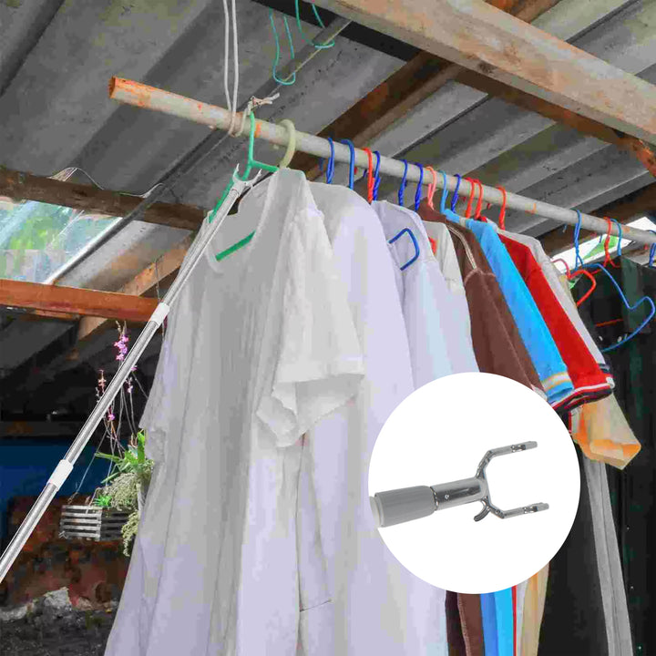 Steel telescopic hanger tool extending to reach clothes on hangers in outdoor setting