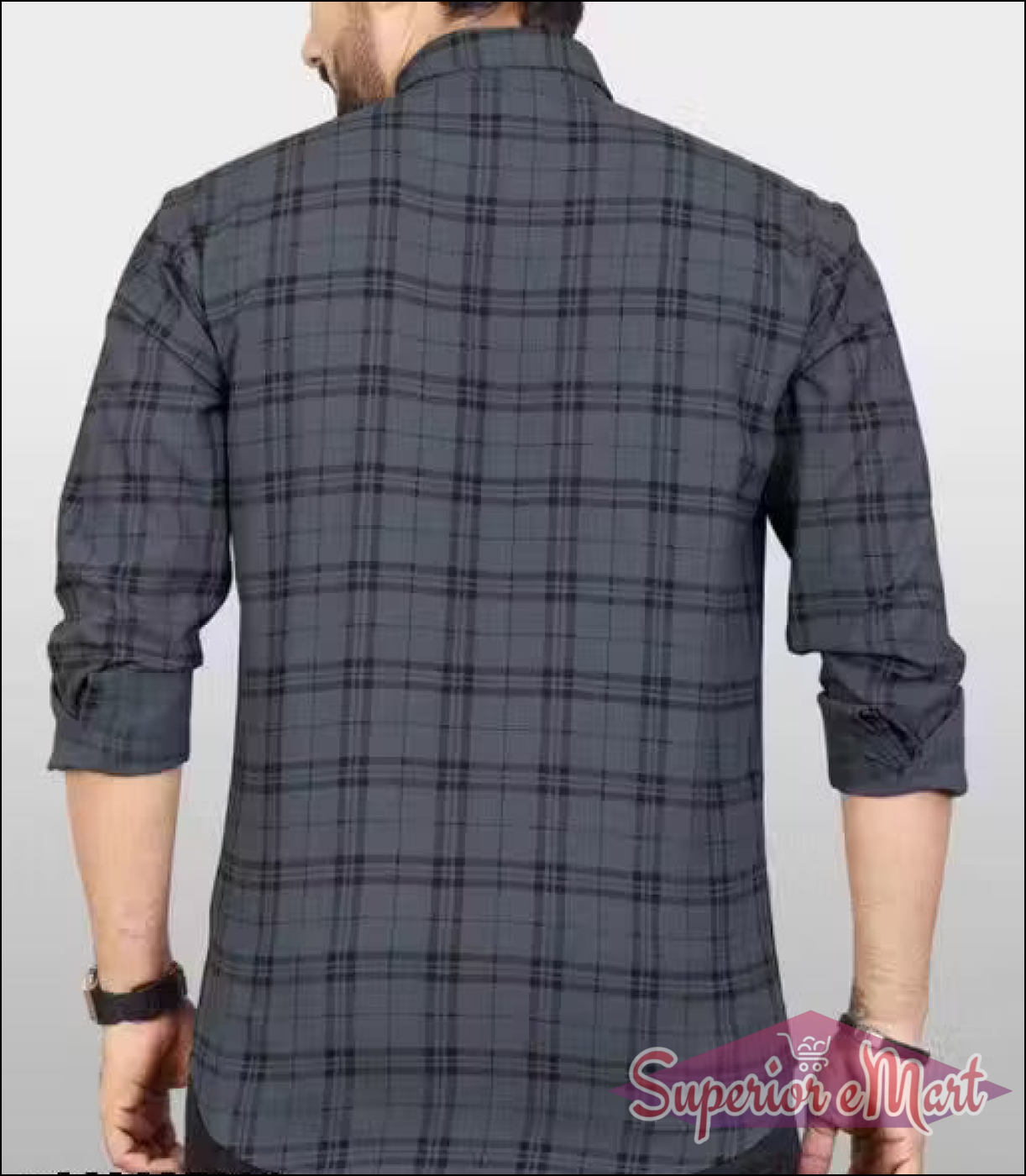 Person wearing a gray plaid shirt on a plain background