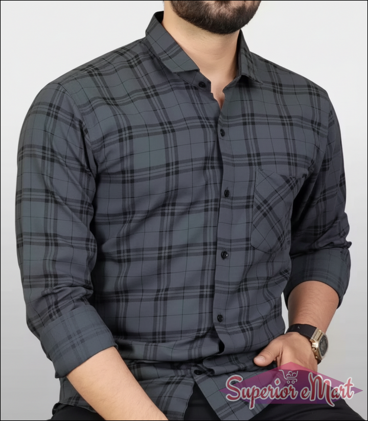Man wearing a gray plaid shirt against a white background