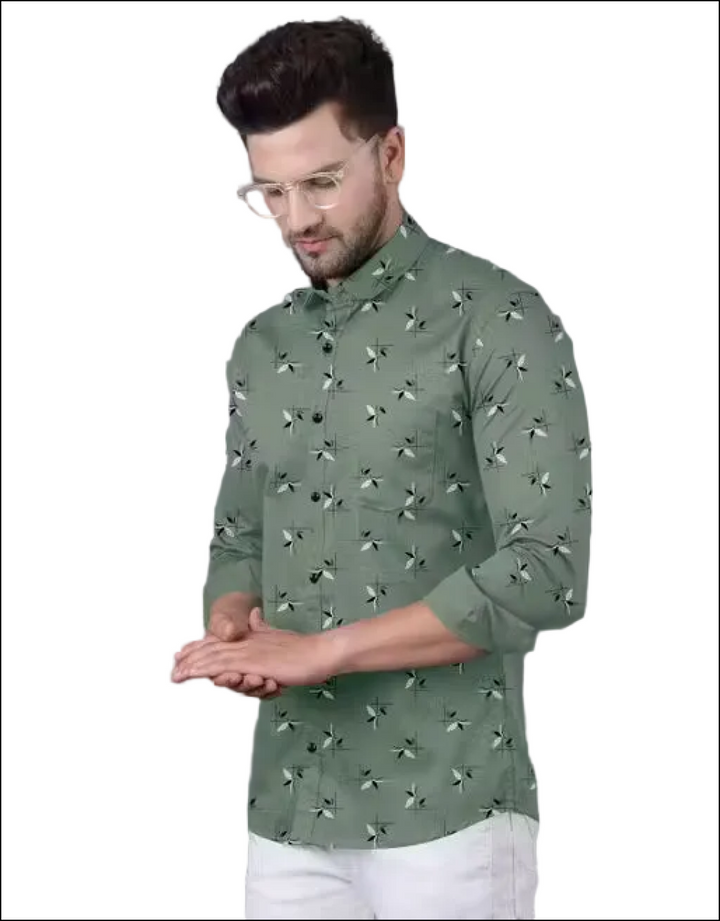 Man wearing a sage green button-down shirt with a small white and black leaf print and a chest pocket.