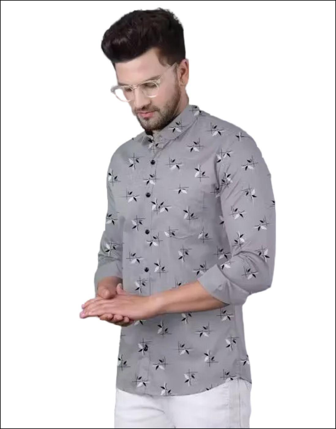 Man wearing a light gray long-sleeve button-down shirt with a black and white abstract print and white trousers.