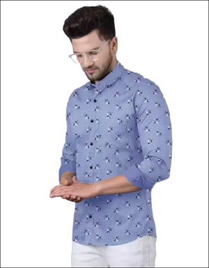 Man wearing a periwinkle blue long-sleeve button-down shirt with a white and black leaf print and white trousers.