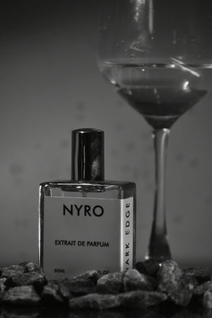 Nyro Elite Set Extrait de Parfum in a 60ml bottle with a cocktail glass and stones in a stylish setting