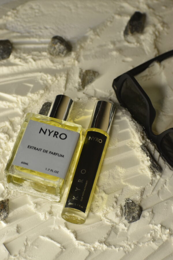 Nyro Elite Set featuring Extrait de Parfum and travel spray on textured surface