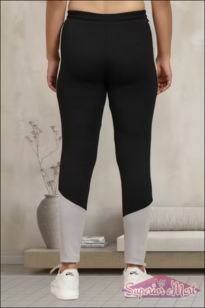 Back view of women's multicolor jeggings featuring black and gray colorblock design for comfort and style