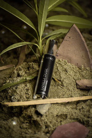 Nyro Vanilla Dusk Perfume in a sleek bottle surrounded by natural elements