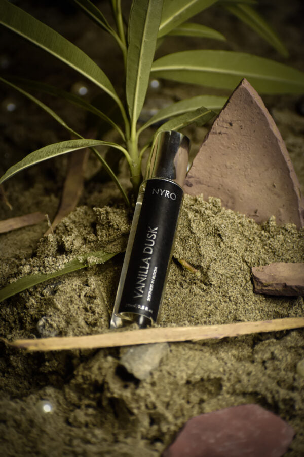 Nyro Vanilla Dusk Perfume in a sleek bottle surrounded by natural elements
