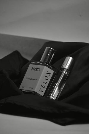 Nyro Velox Perfume Bottles on Black Silk with Elegant Packaging for a Luxurious Fragrance Experience