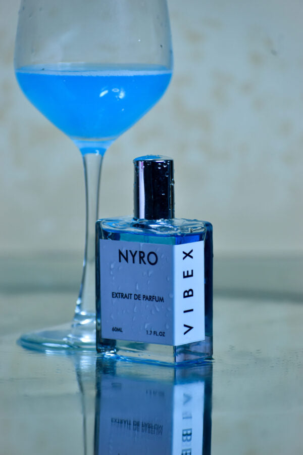 Nyro Vibex Extrait de Parfum in a stylish bottle with a light blue fragrance beside a blue drink