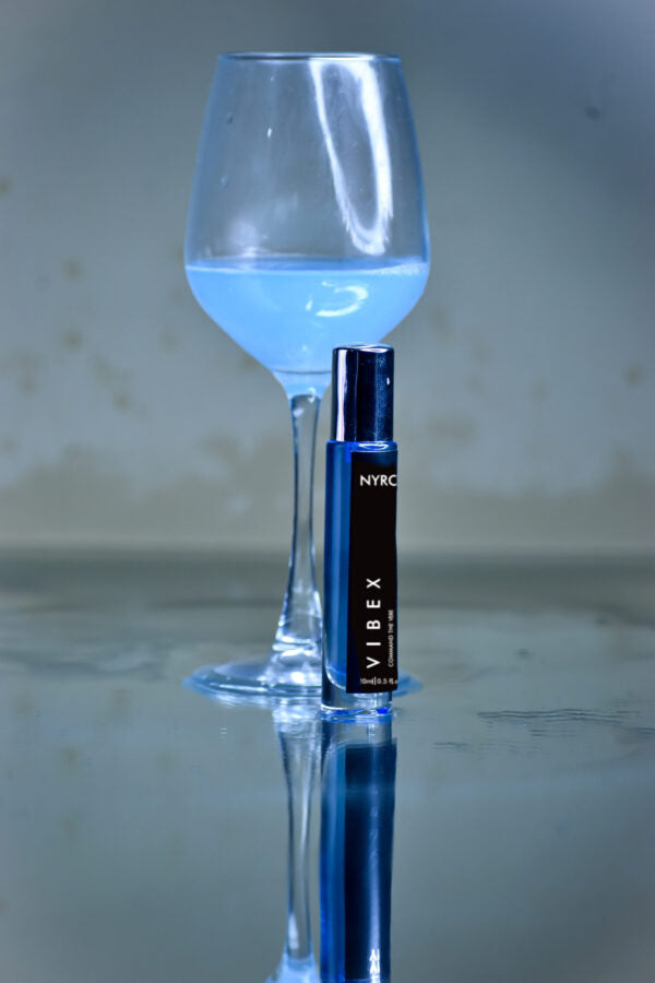 Nyro Vibex Perfume Bottle with Elegant Glass and Blue Fragrance Reflected on a Surface