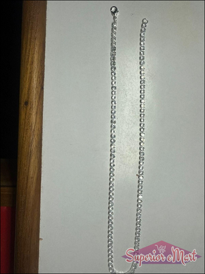 Sparkling silver-tone tennis necklace with a row of round clear stones and a lobster claw clasp.