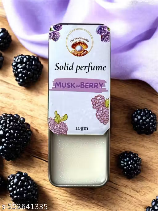 Musk berry solid perfume in metal tin with lavender and blackberry design on wooden background