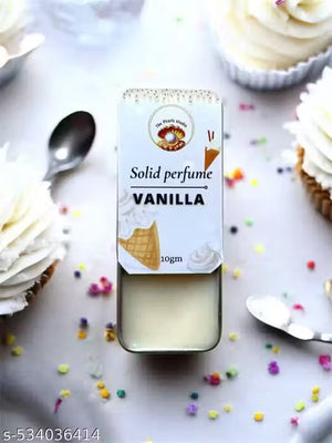Vanilla solid perfume balm in a stylish tin with cupcakes and colorful sprinkles in the background
