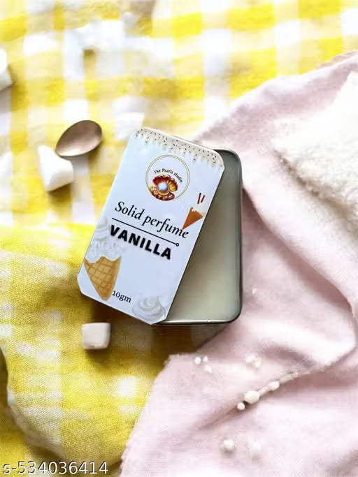 Vanilla solid perfume balm in a tin with a soft cream texture against a yellow checkered background