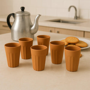 Traditional chai cups set of six in terracotta, perfect for enjoying tea, with a teapot and snacks in the background