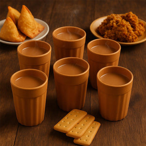 Traditional chai cups set displayed with snacks on a wooden table for an authentic tea experience